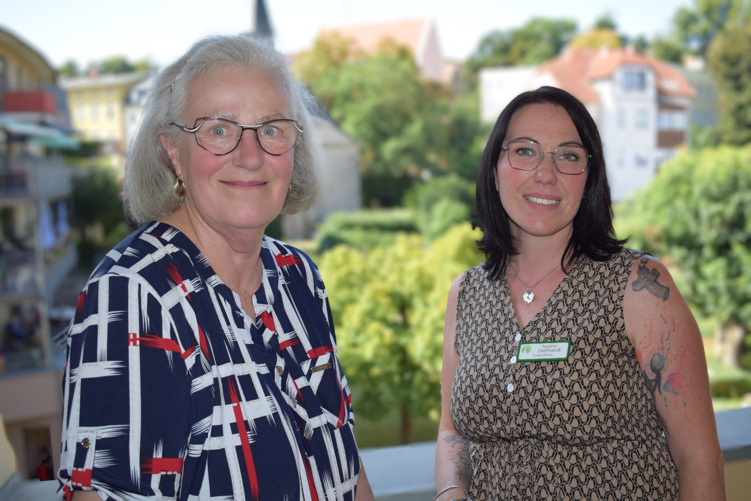 zwei Frauen: Nadine Gebhadt auf der rechten Seite und Jutta Fischer auf der linken Seite. Im Hintergrund die Nicolaikirche und Bäume